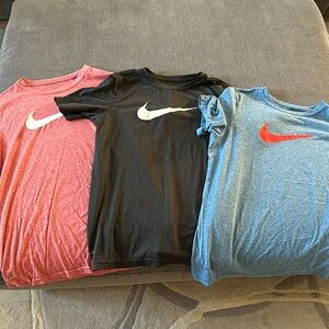 Set of three Boys Nike Dri Fit tshirts, colors black, red and blue.